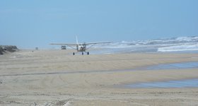 The beach acts as a road and a runway (and also a beach).
